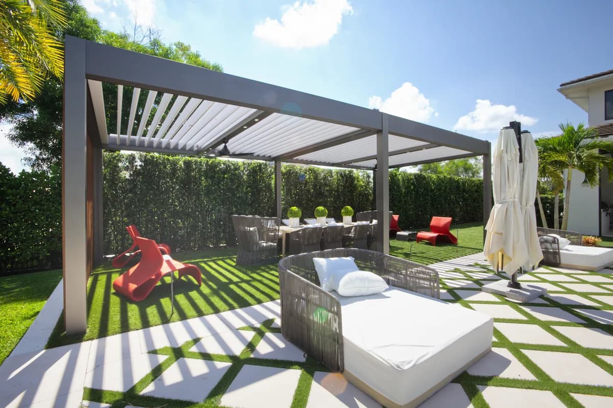 Azenco Outdoor R-BLADE motorized louvered pergola beside a pool