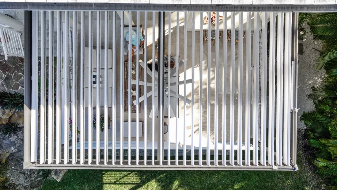 Aerial view of an Azenco Outdoor R-BLADE pergola with louvers open