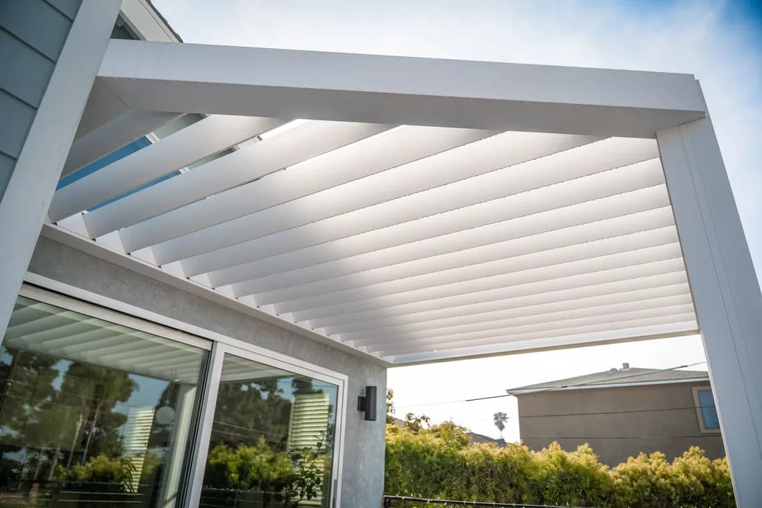 Attached Azenco Outdoor R-BREEZE fixed-louver pergola in white