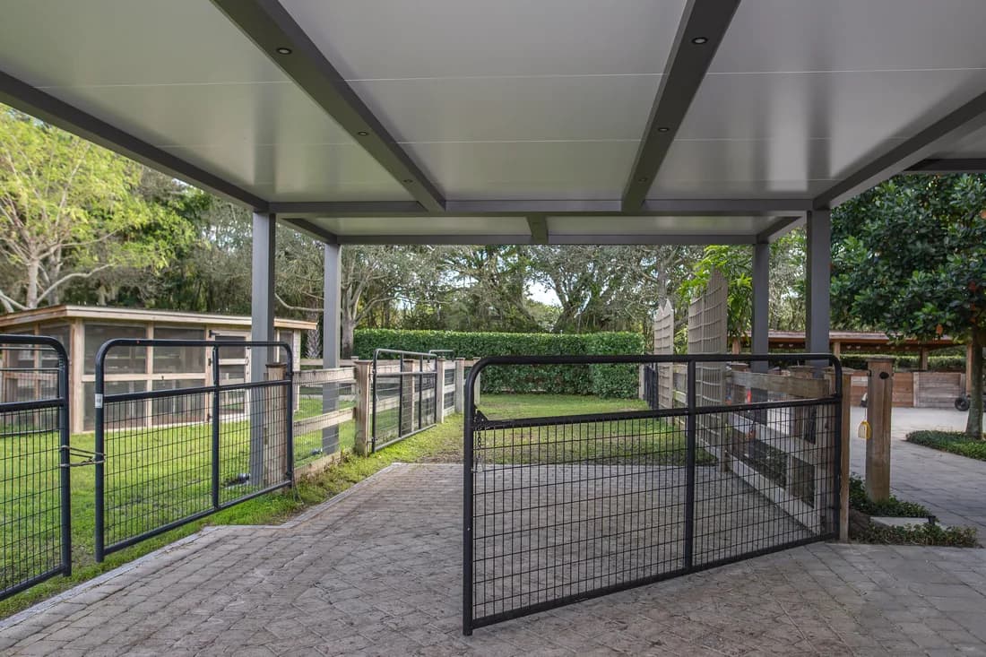 Azenco Outdoor R-SHADE insulated cover sheltering a paved outdoor area