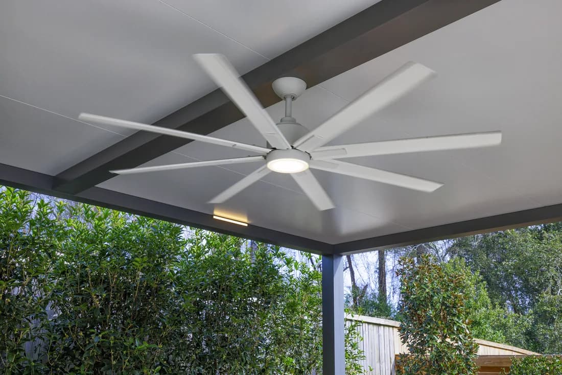 Underside of an Azenco Outdoor R-SHADE patio cover with a large ceiling fan