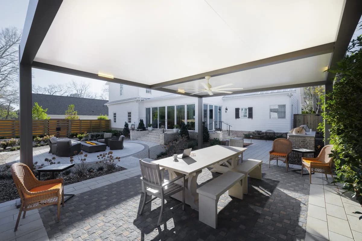 Azenco Outdoor R-SHADE insulated patio cover over an outdoor dining area