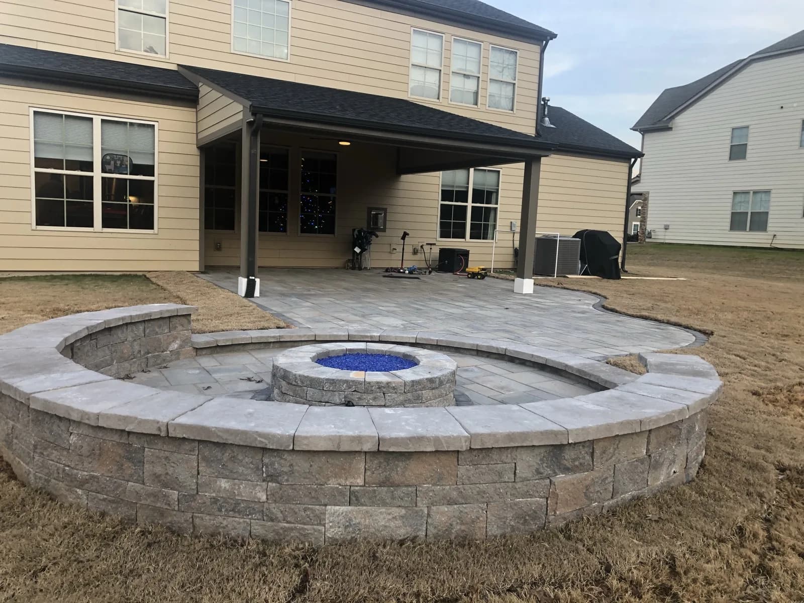 Paver patio with a stone fire-pit seating wall in Charlotte, NC